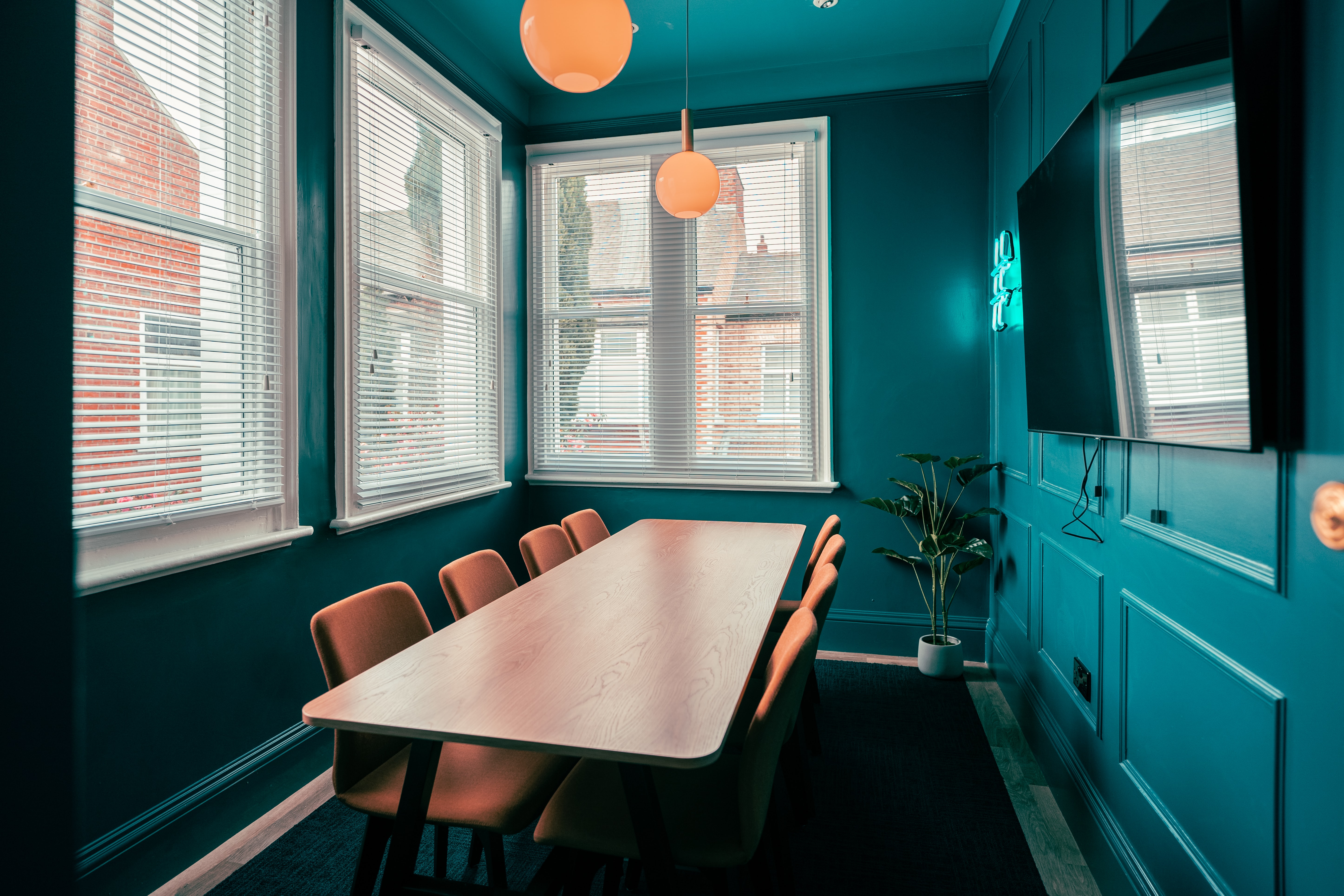 Photo of a conference room with windows and TV.